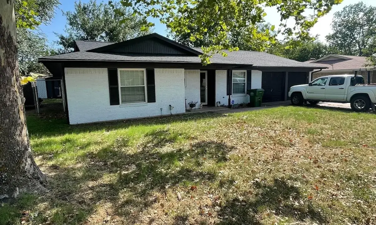 Professional roofing crew working on a residential roof in Denham Springs